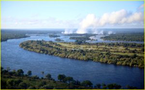 Flying over Zambezi River near Victoria Falls (in the background). Zambia on the left bank, Zimbabwe on the right