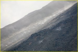 Hot magma chunks rolling down the Arenal Volcano crater