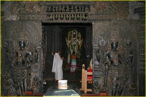 Priests (brahmins) in action in the inner sanctum of Chennakeshava Temple, Belur, Karnataka
