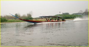 Long-tailed boat with propeller on a very long shaft - a common sight on Thailand's inland and coastal waters