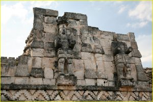 Two atlantes (male figures used as supporting columns) on the Eastern facade of El Palacio de los Mascarones, Kabah